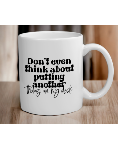 Funny office desk quote mug on wooden table with black text design
