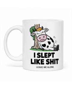 Funny rude I Slept Like Shit cow mug shown on a clean white background.
