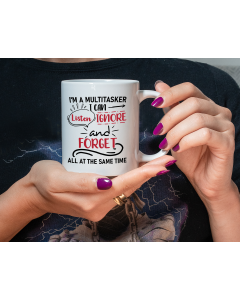 Funny multitasker quote mug held in hands with black and red text design