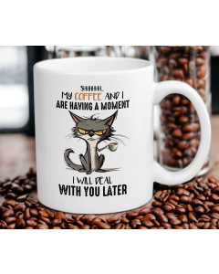 Funny grumpy cat coffee mug on table with coffee beans
