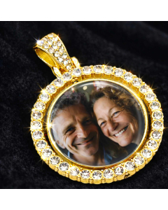 Personalised gold photo pendant with rhinestone edge close-up on dark fabric