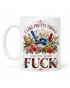 White ceramic mug on a pure white background at a slight angle, featuring a blue wren and Australian floral artwork with the phrase “I Like Pretty Things and the Word Fuck.”