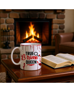 True Crime Queen funny white ceramic mug on table near fireplace